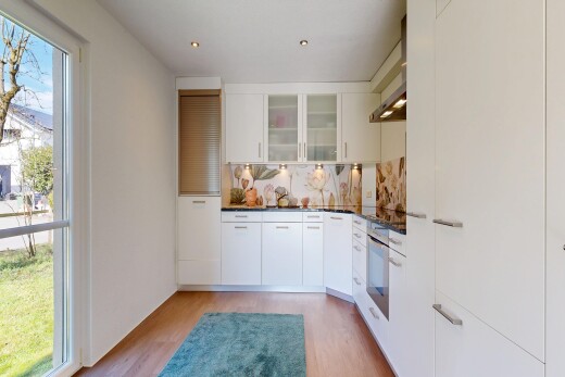 kitchen featuring white cabinets, glass fronted cabinets, light wood-type flooring, stainless steel oven, and backsplash
