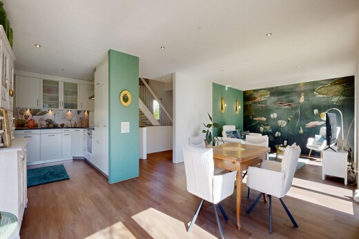 dining area featuring dark wood-type flooring and an accent wall