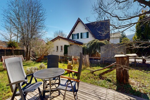 view of home featuring outdoor dining space, stucco siding, and a deck