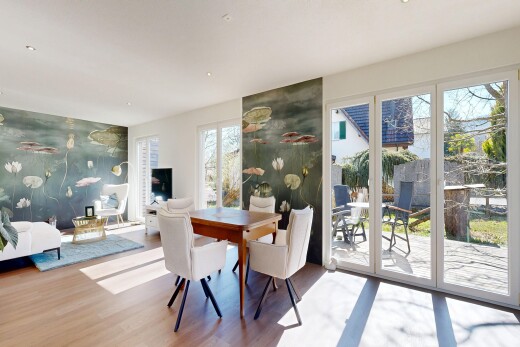 living / dining room with an accent wall and light wood-style flooring