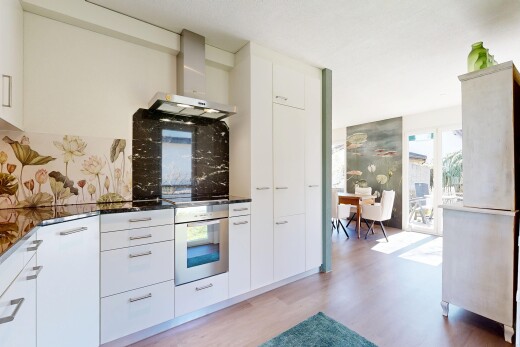 kitchen featuring oven, white cabinetry, light wood-style floors, and modern cabinets