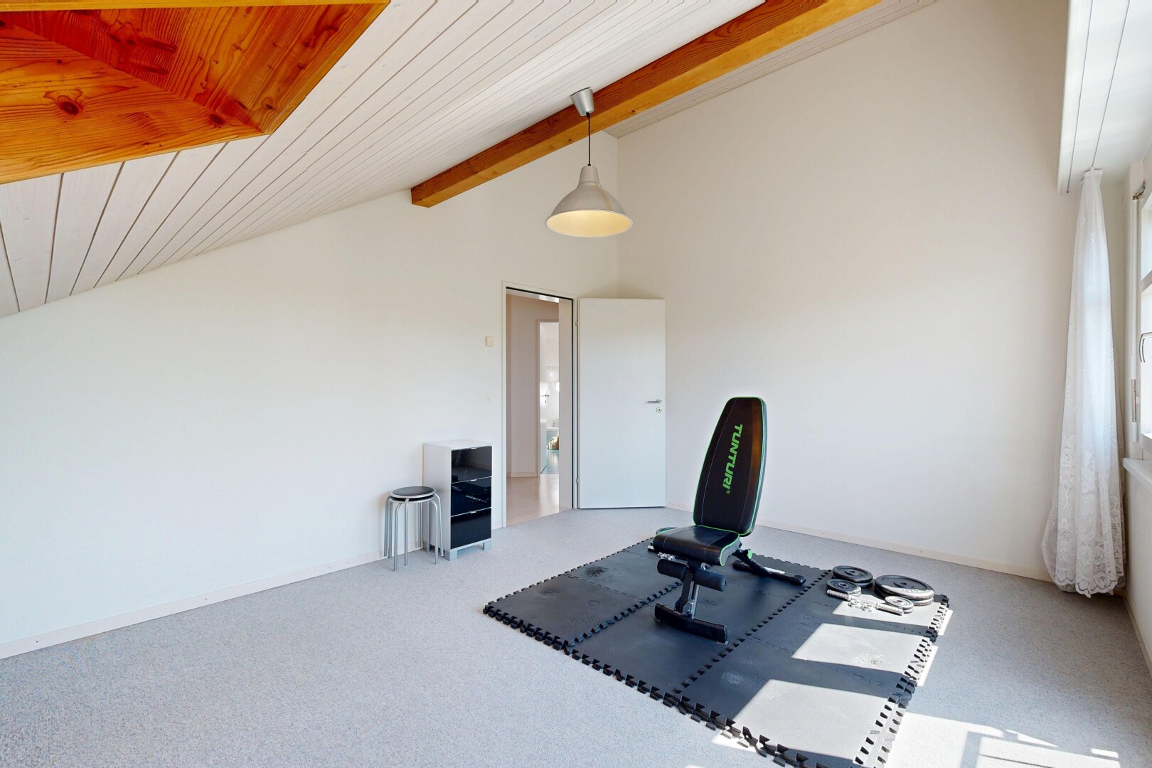 fitnessstudio mit dachschräge, vaulted ceiling, holzdecke, wood ceiling, und teppich