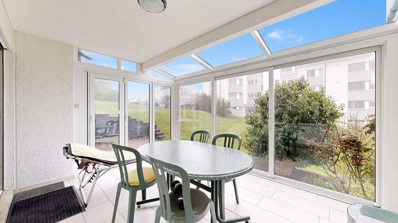 terrace featuring a sunroom and outdoor dining area