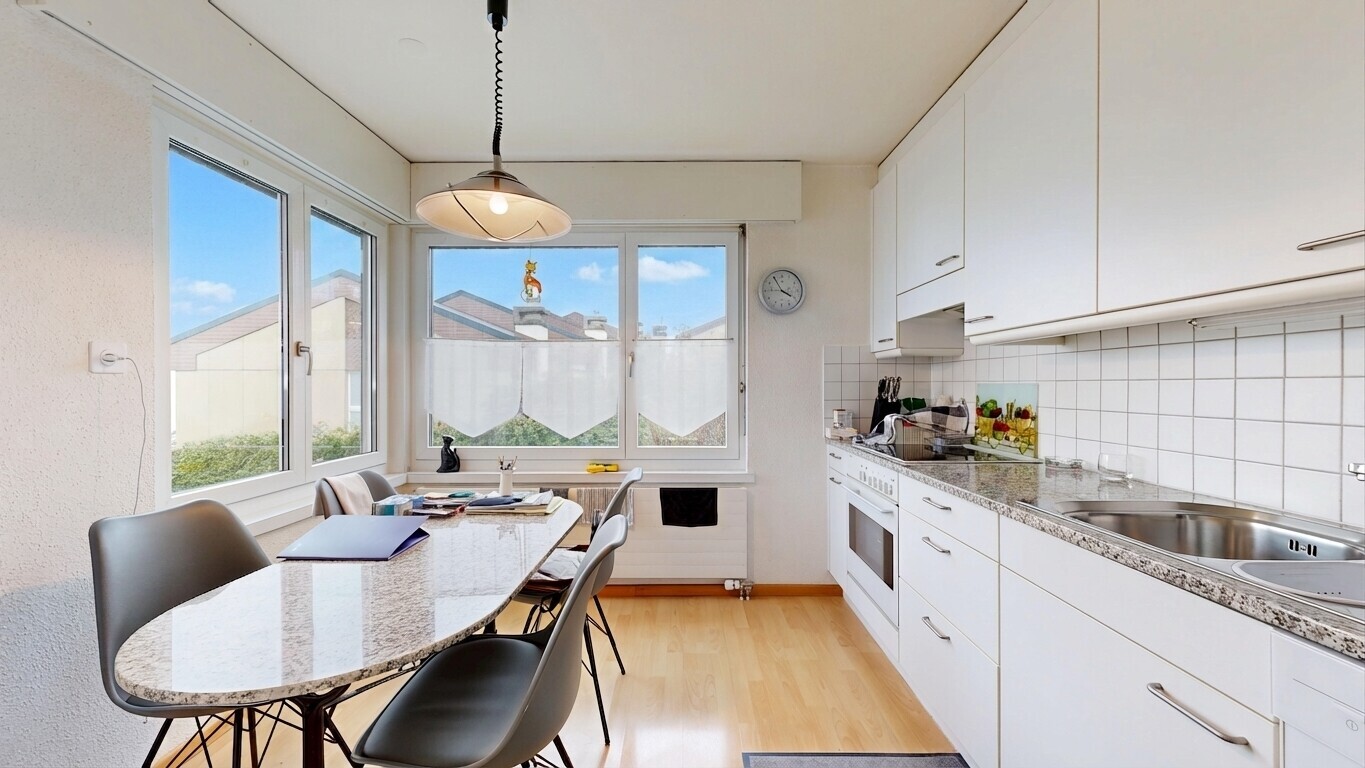 kitchen with white cabinets, light wood-style flooring, oven, pendant lighting, and tasteful backsplash