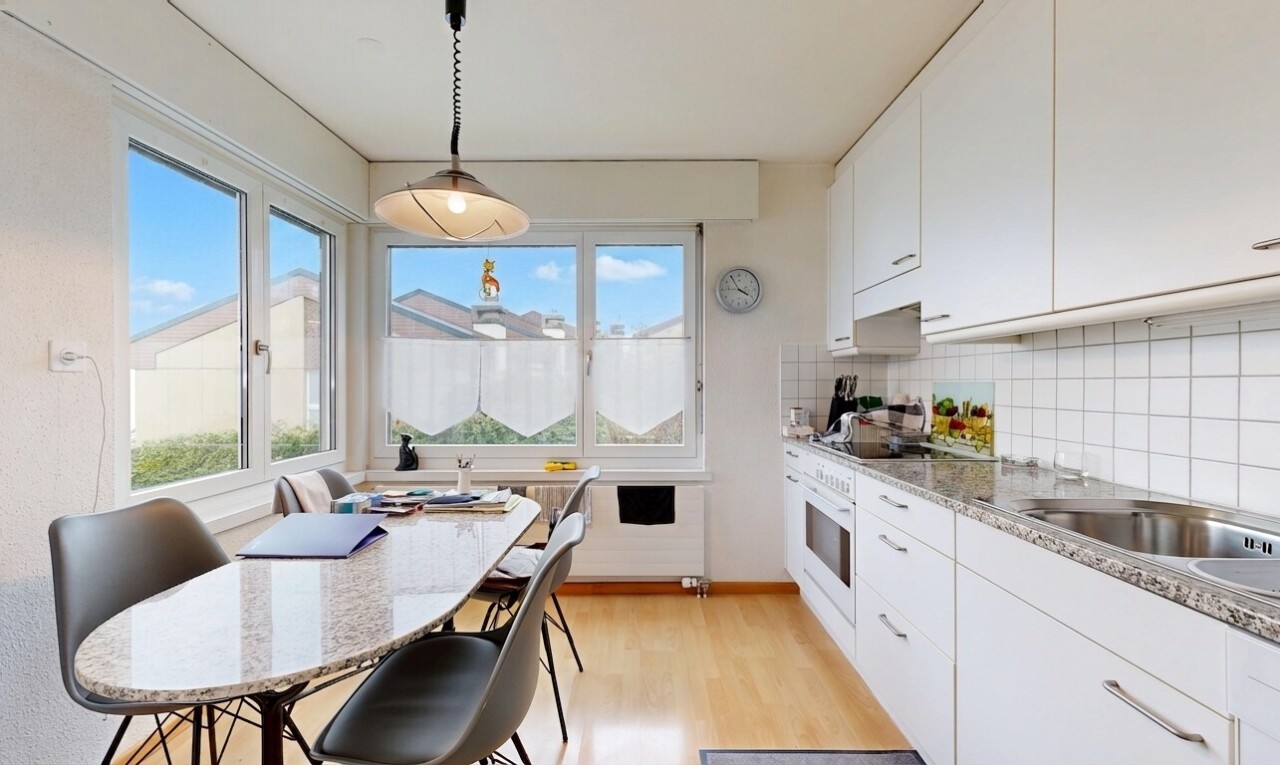 kitchen with white cabinets, light wood-style flooring, oven, pendant lighting, and tasteful backsplash