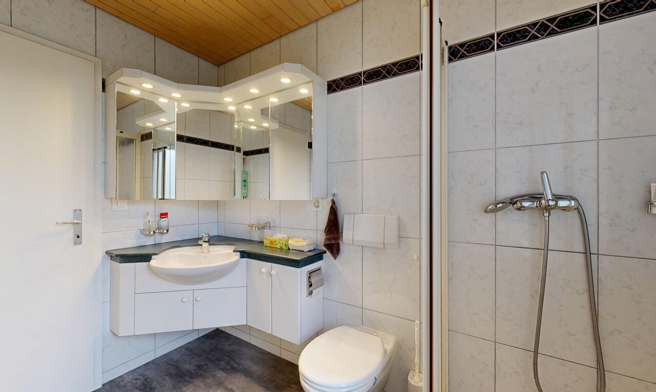 bathroom with vanity, tile walls, a stall shower, and wood ceiling