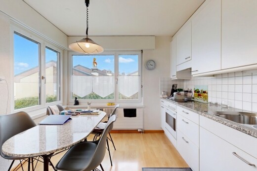 küche mit day time, light countertops, white cabinets, weiße schränke, und light floor