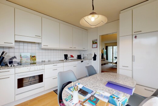 küche mit ofen, light countertops, light floor, inside property, und white cabinets