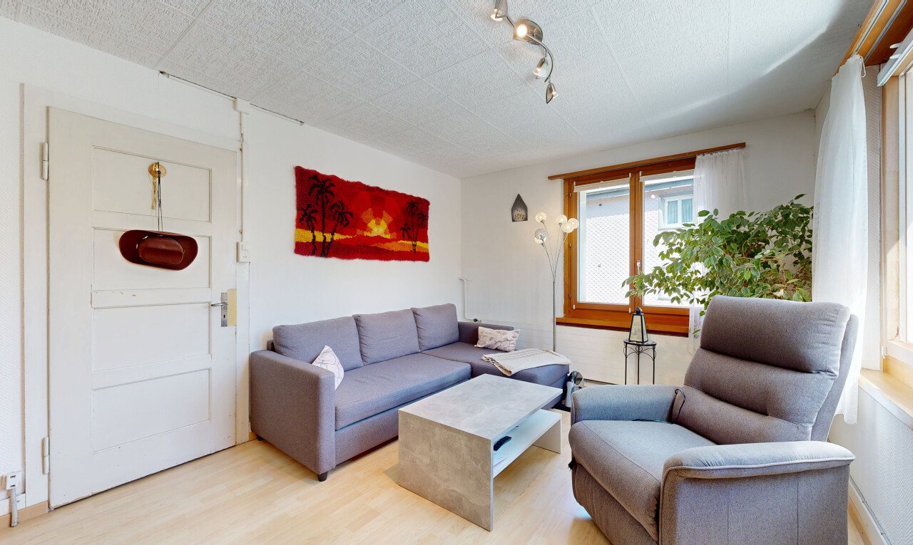 salon avec éclairage sur rail, wood finish floor, sol en finition bois, inside property, et drywall