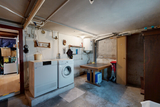 laundry area featuring unfinished concrete floors, gas water heater, and washer and dryer