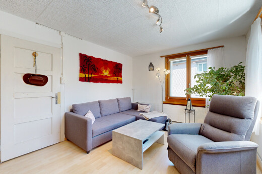 salon avec éclairage sur rail, wood finish floor, sol en finition bois, inside property, et drywall