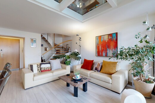 living area featuring wood finished floors and stairway
