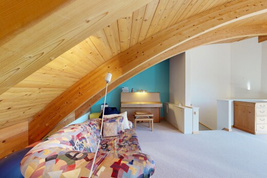room featuring a wood ceiling with exposed beams and carpet flooring