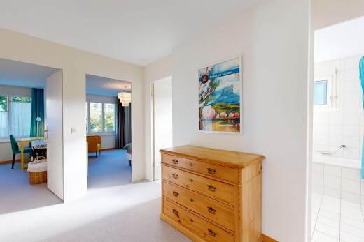 hallway with light colored carpet