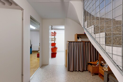 hall featuring stairway and dark speckled floor
