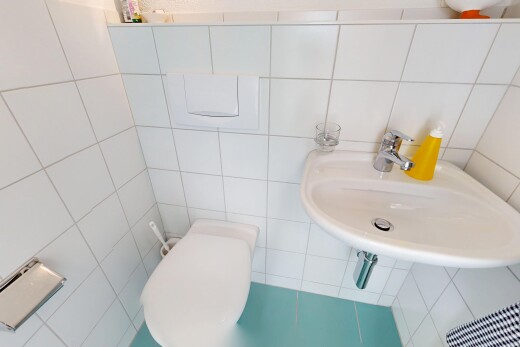 half bathroom with a sink and tile walls