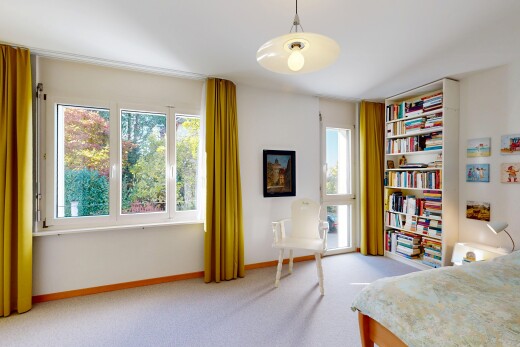 room featuring decorative light fixtures and light colored carpet