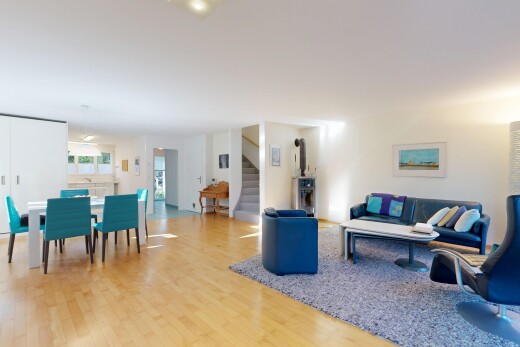 salon / salle à manger avec escaliers, cloison sèche, drywall, carpet stairs, et sol en finition bois