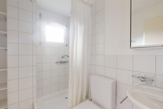 full bath featuring a stall shower and tile walls