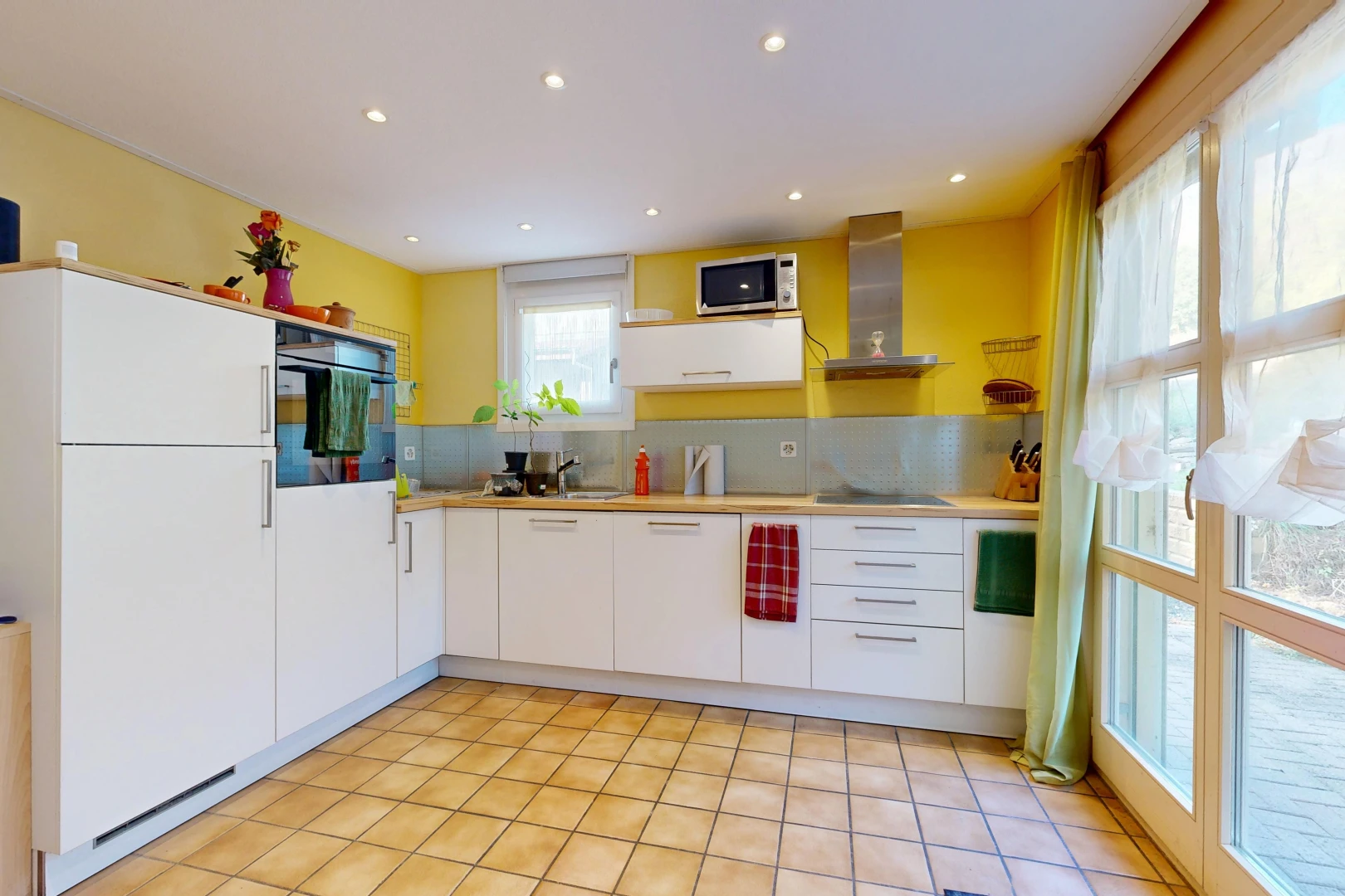 kitchen featuring light countertops, recessed lighting, black appliances, and white cabinetry