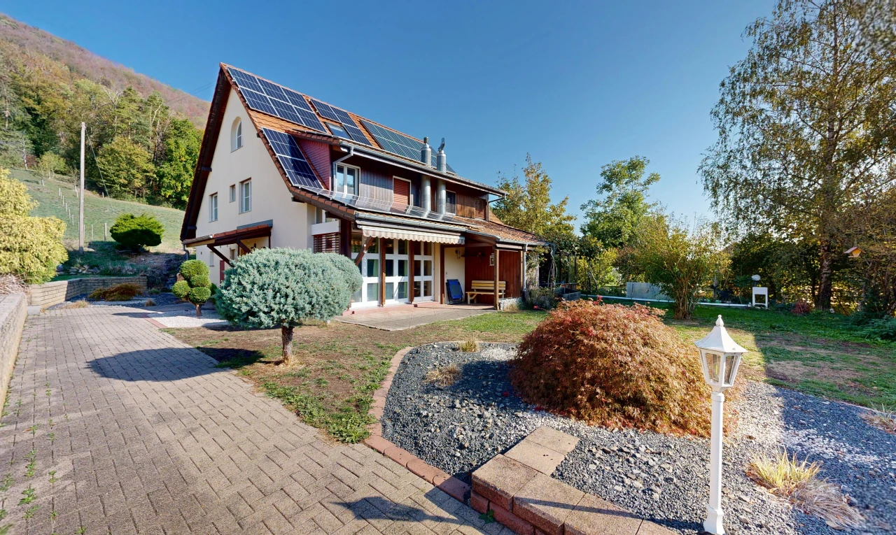 outdoor house with solar panels and a garage