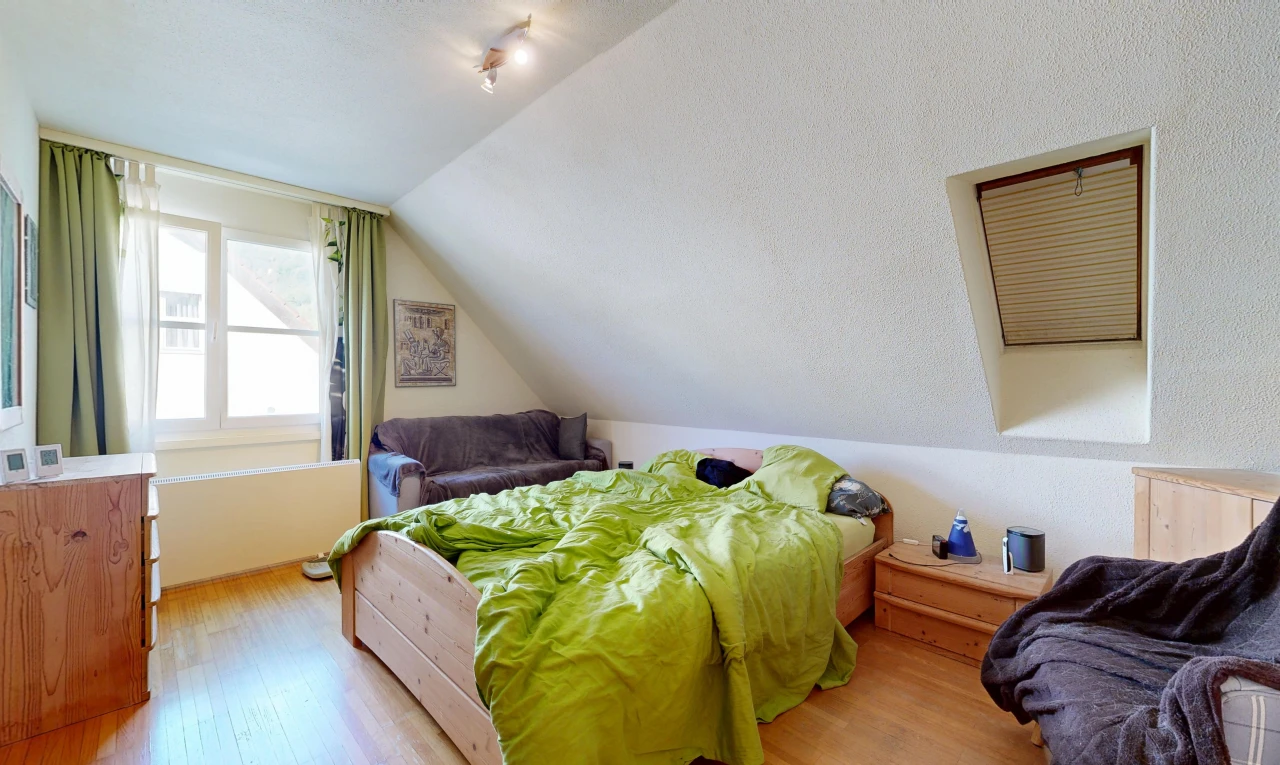 room featuring lofted ceiling, light wood-style floors, and track lighting