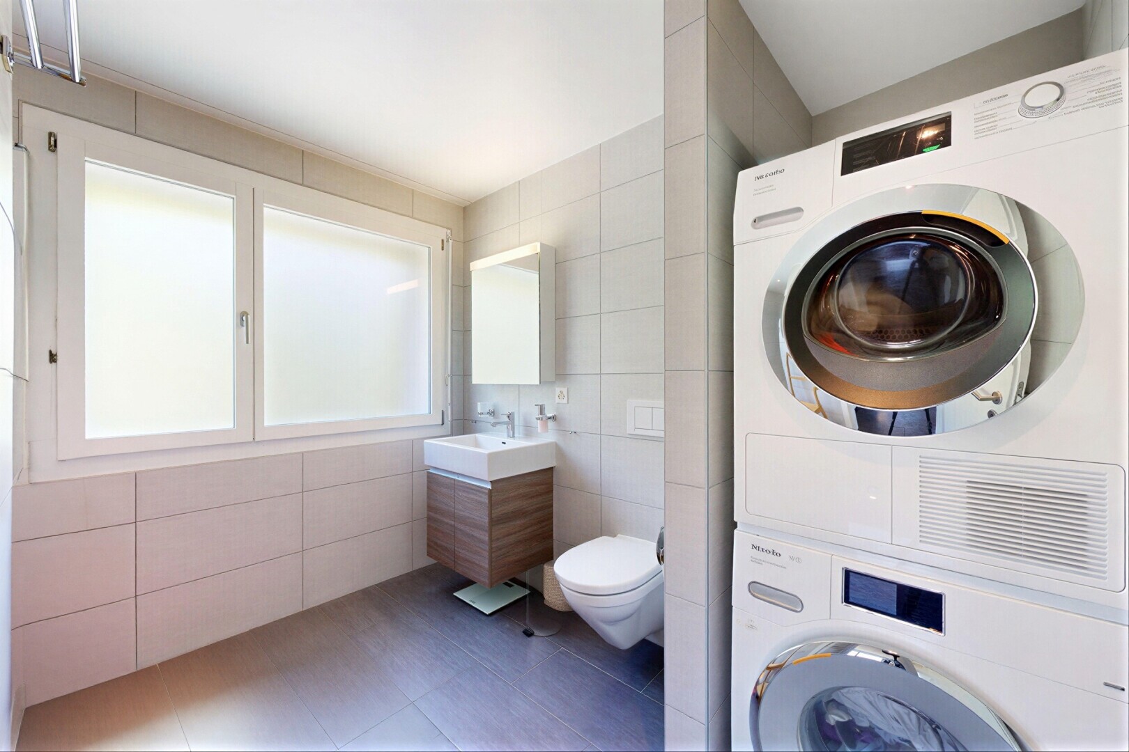 bathroom with tile walls, stacked washer / dryer, vanity, and tile patterned floors