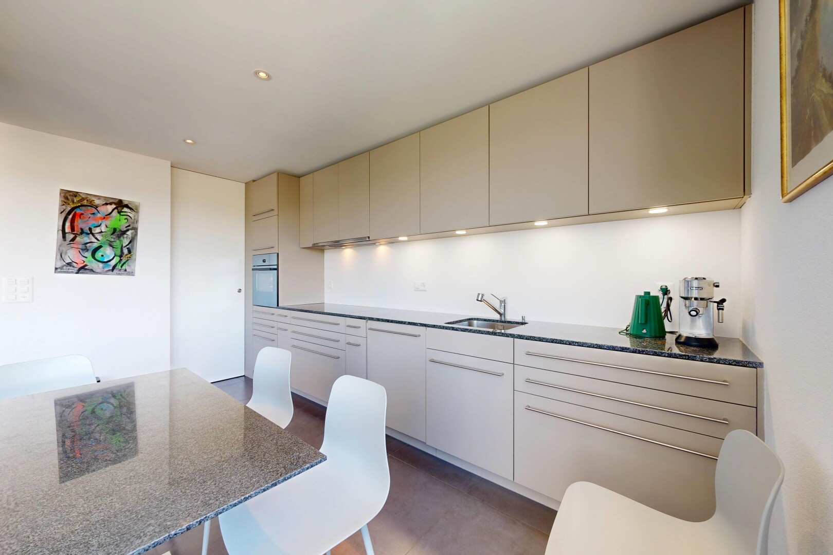 kitchen featuring cream cabinets, wall oven, recessed lighting, and dark stone countertops