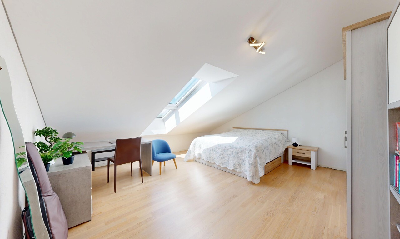 room / bedroom with a skylight, light wood-style floors, and lofted ceiling