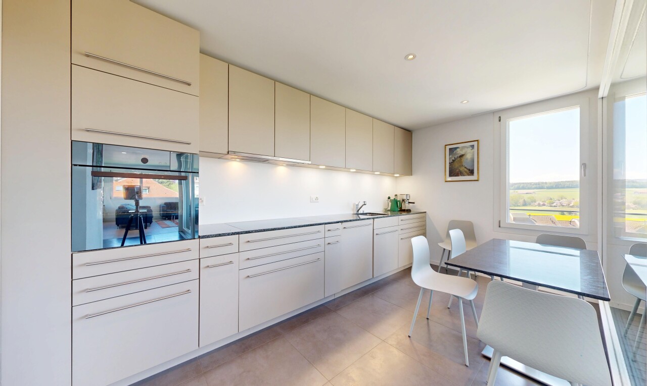 kitchen featuring black oven, cream cabinets, healthy amount of natural light, recessed lighting, and dark countertops