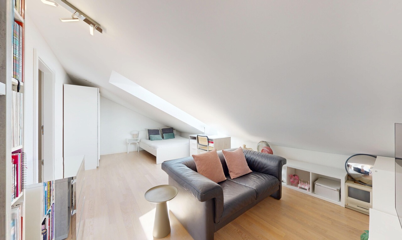 living room with light wood-type flooring, vaulted ceiling, and rail lighting