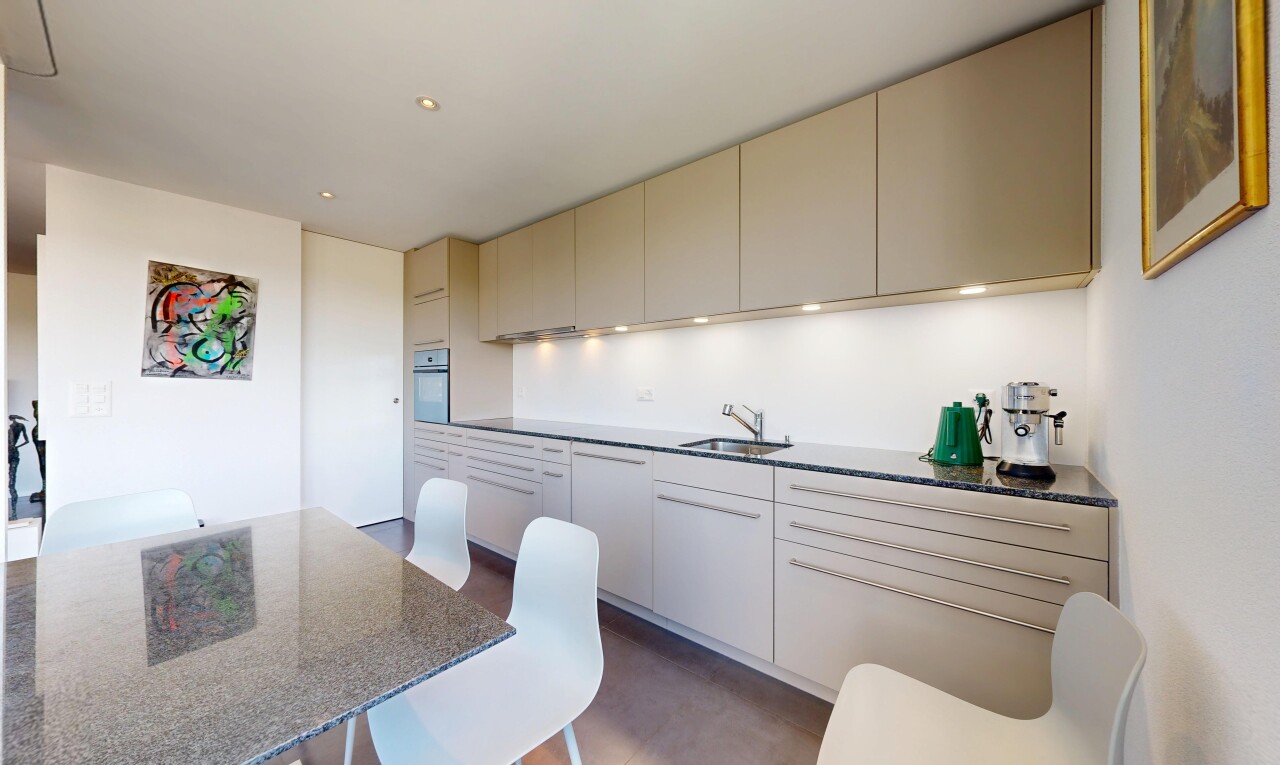 kitchen featuring cream cabinets, wall oven, recessed lighting, and dark stone countertops
