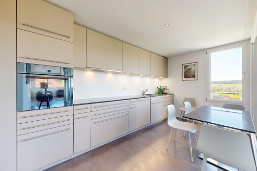 kitchen featuring black oven, cream cabinets, healthy amount of natural light, recessed lighting, and dark countertops