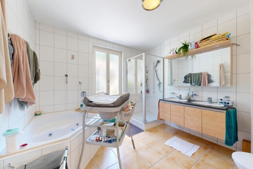 salle de bains avec mur en carrelage, tile wall, bain, double vasque, et douche