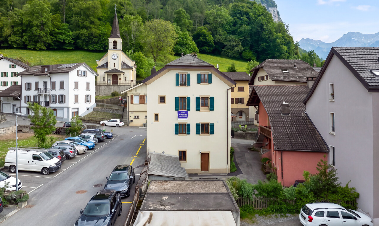 façade avec bardage en stuc, parking, et day time