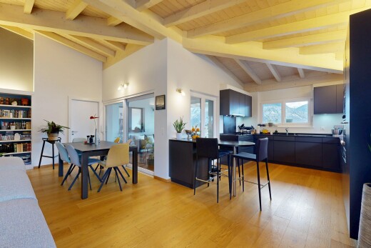 living / dining area featuring light wood finished floors, high vaulted ceiling, and a wood ceiling with exposed beams