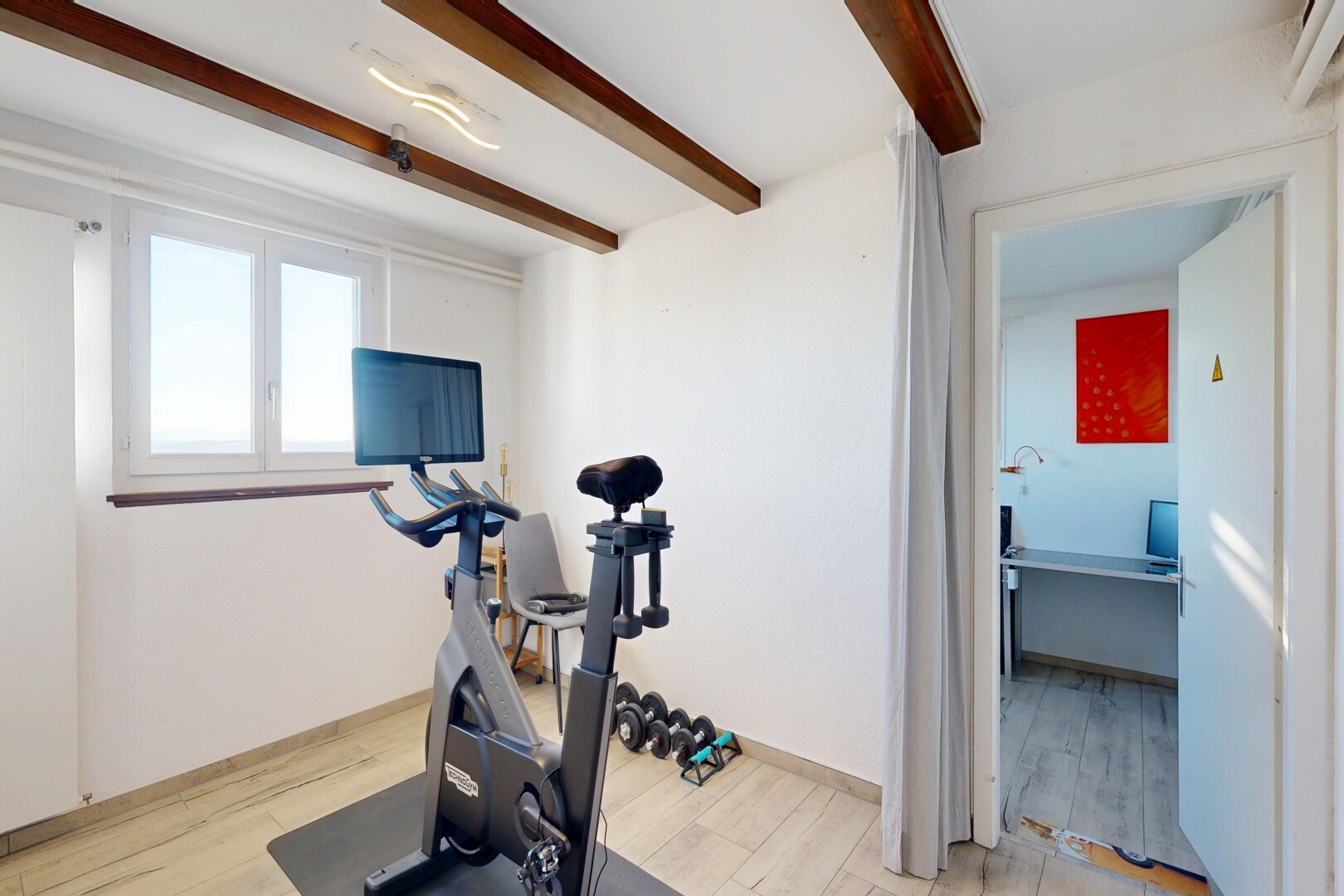 gym with beamed ceiling and light wood finished floors