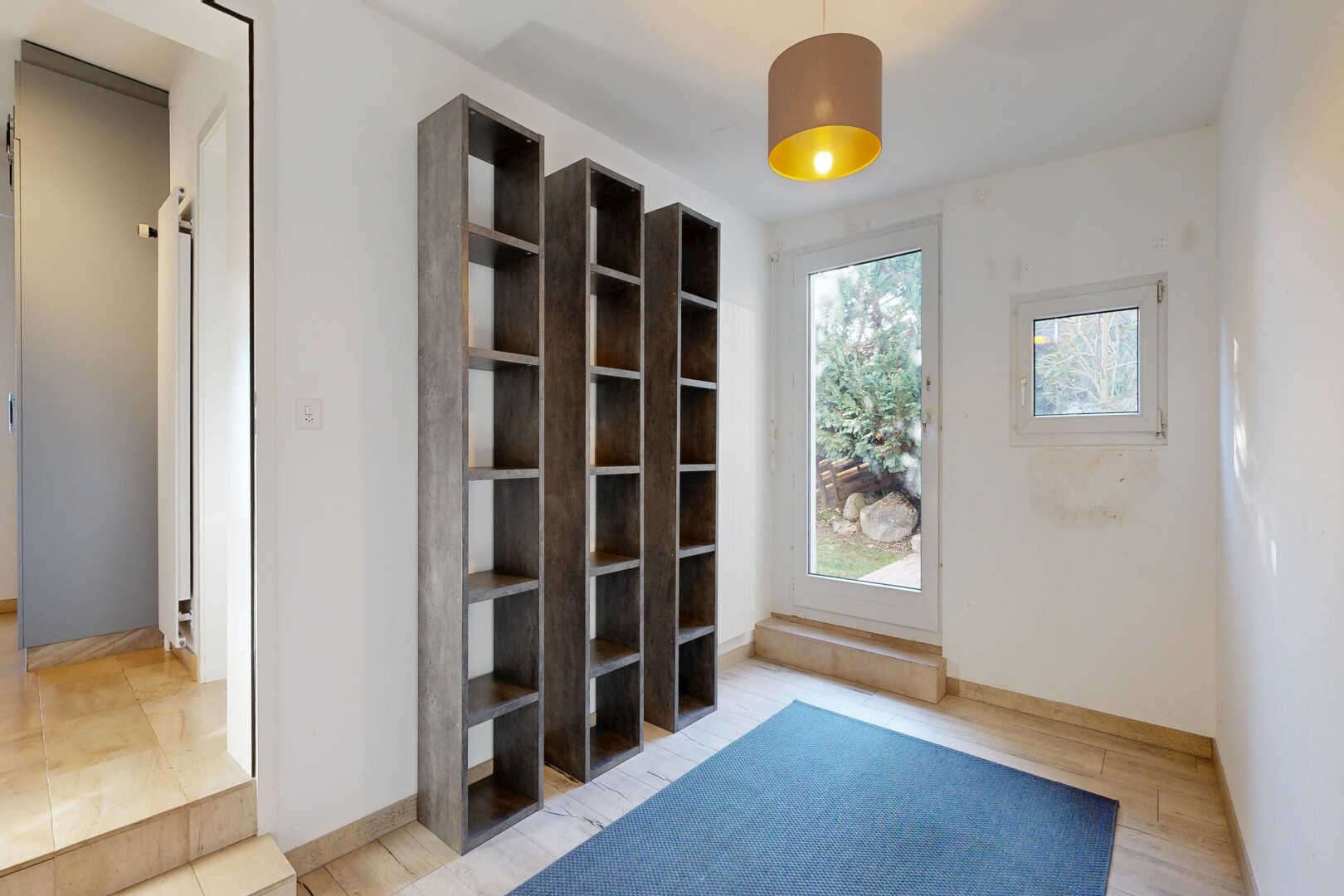 unfurnished room with baseboards and light wood-style flooring