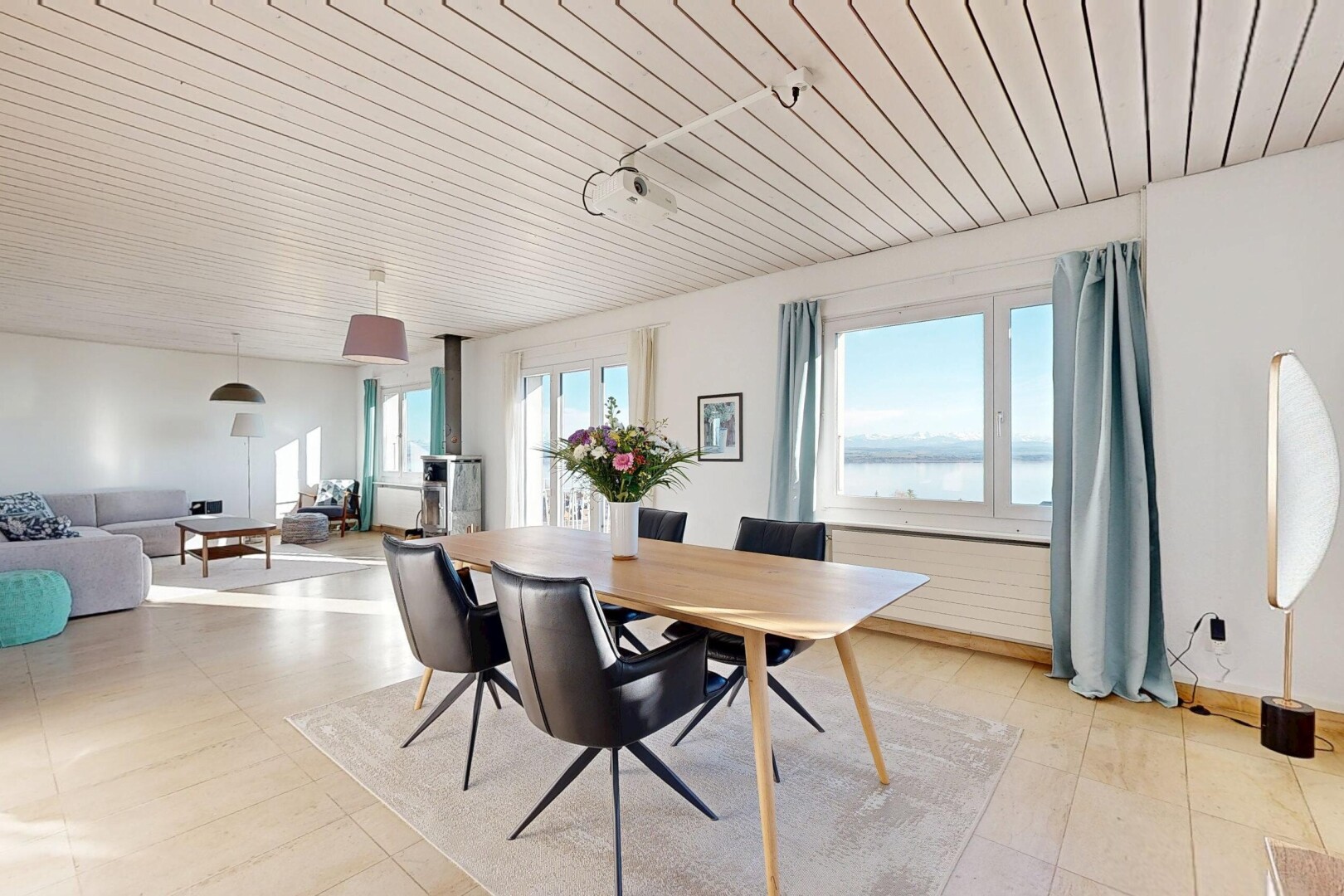 living / dining area with wooden ceiling and a water view