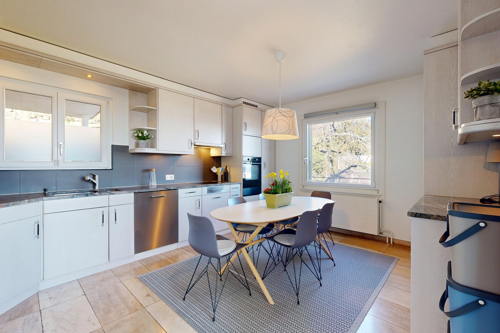 kitchen featuring open shelves, dark countertops, stainless steel dishwasher, hanging light fixtures, and tasteful backsplash