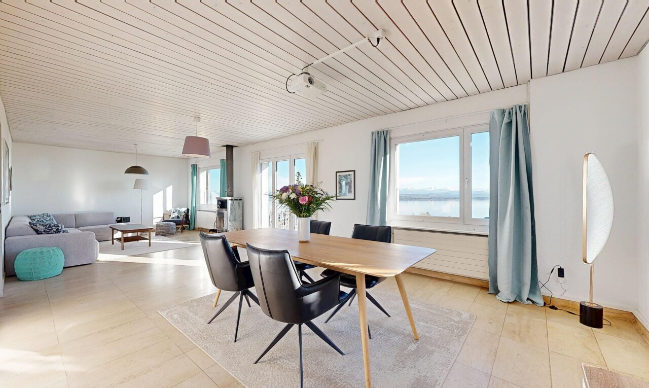 living / dining area with wooden ceiling and a water view