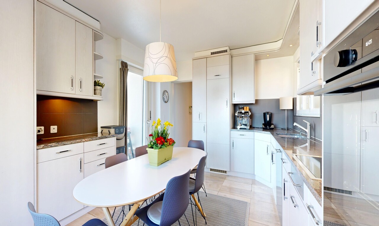 kitchen with stainless steel oven, white cabinetry, black electric cooktop, open shelves, and dark stone countertops