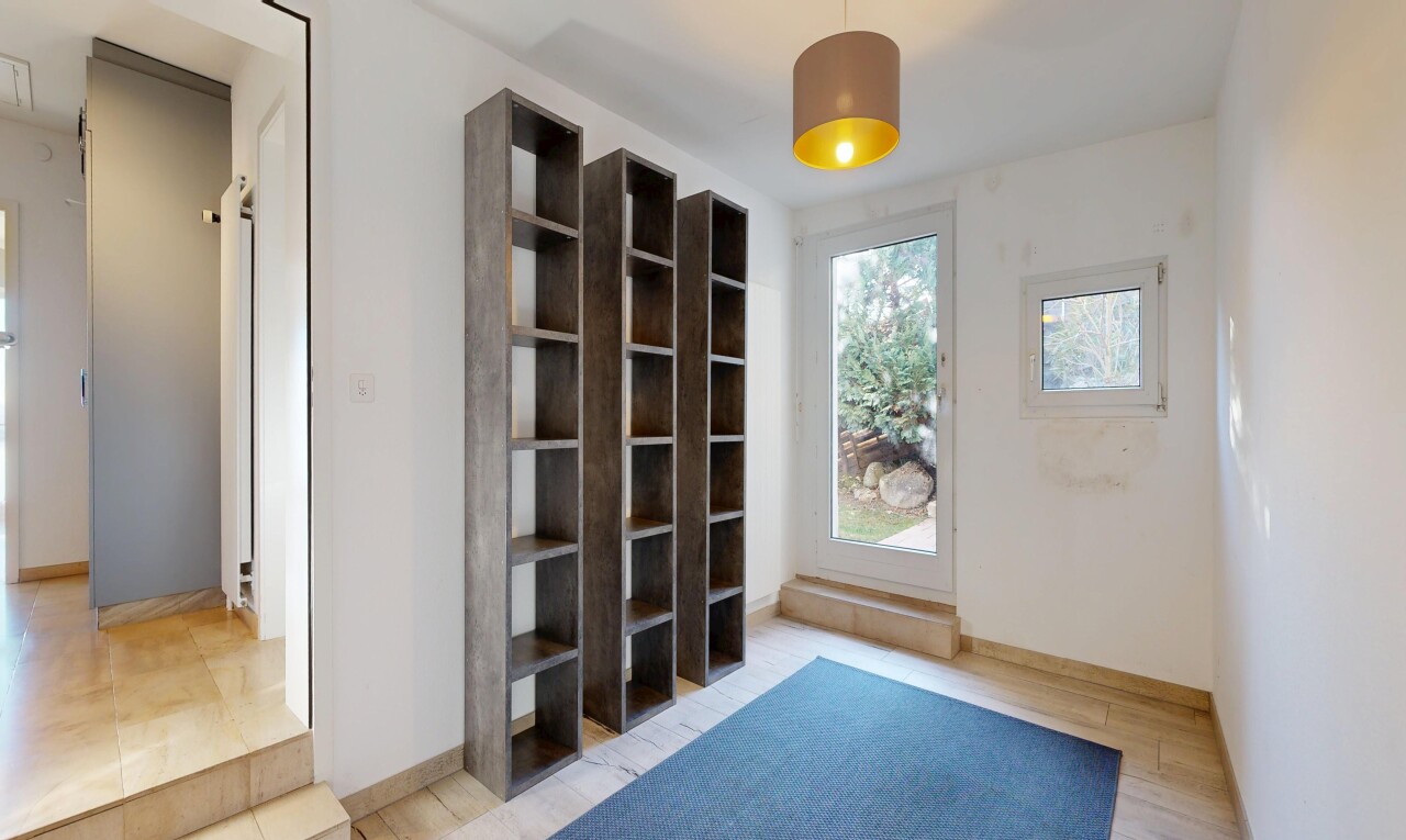 unfurnished room with baseboards and light wood-style flooring