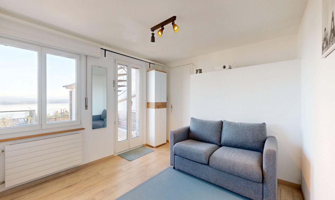 living room featuring light wood-style flooring, radiator heating unit, and track lighting