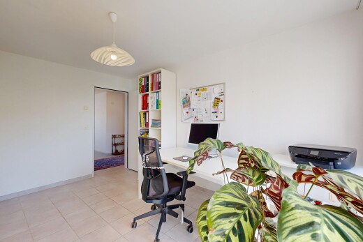home office featuring decorative light fixtures and light tile patterned floors