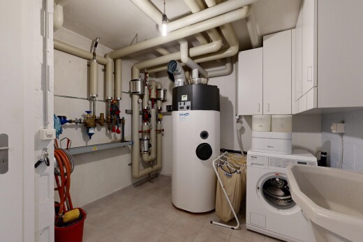 laundry room with water heater, washer / clothes dryer, and cabinet space