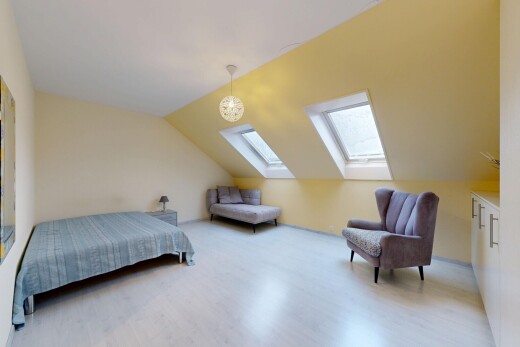 room with vaulted ceiling, wood finished floors, and a skylight