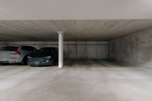 view of parking with a parking deck