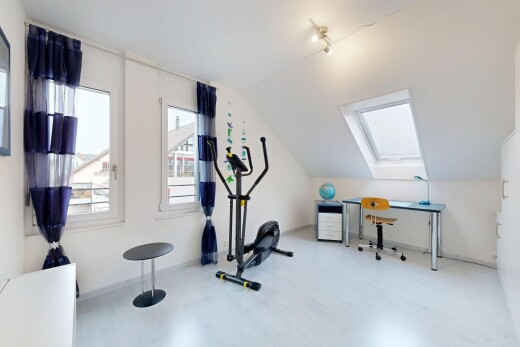 exercise room with lofted ceiling, a skylight, and wood finished floors