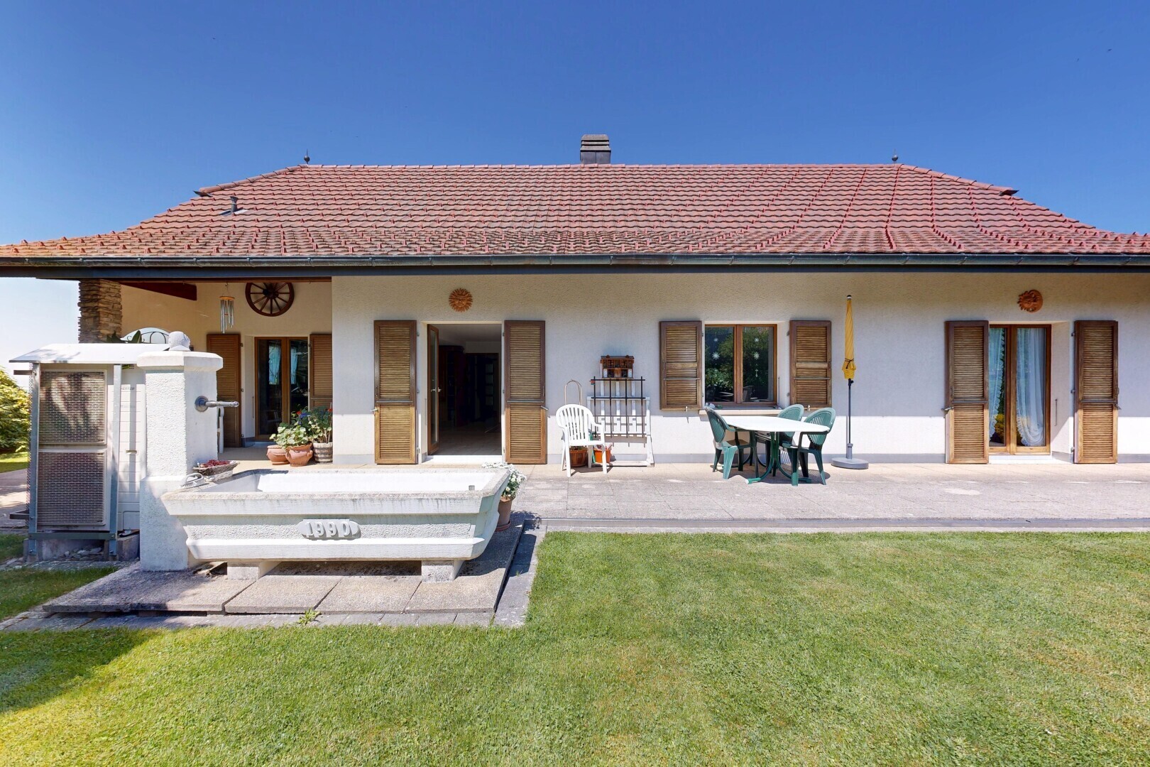 outdoor house featuring a yard, stucco siding, and a patio area